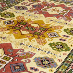 Caucasian Kazak design wool rug, cream field with three large geometric medallions and stylised hooked motifs, enclosed by polychrome reciprocal border and green floral guard stripes