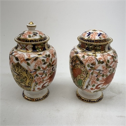 Three Bloor Derby Imari pattern twin handle urms, two examples with covers, each with mark beneath, H12cm, (all a/f), together with a pair of late 19th century Royal Crown Derby Imari pattern urns and covers, each with mark beneath, H13cm, (one significantly a/f). 
