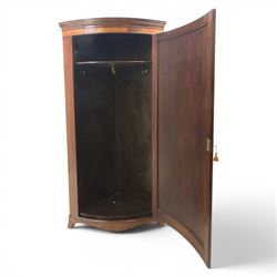 Edwardian inlaid mahogany cylindrical corner hall-robe, projecting cornice, figured veneer and crossbanded door, enclosing hanging hooks and shelf, raised on a plinth base with bracket feet