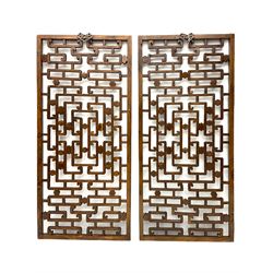 Pair 19th century Chinese lattice wall panels, in moulded frames with metal hangers, decorated with carved flower head