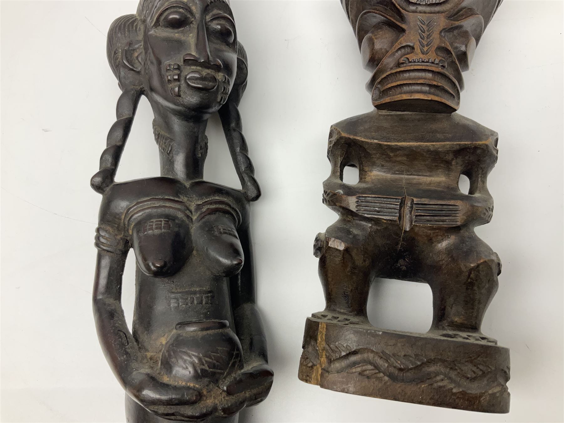 Carved african figures, together with a polynesian figure, largest H38cm