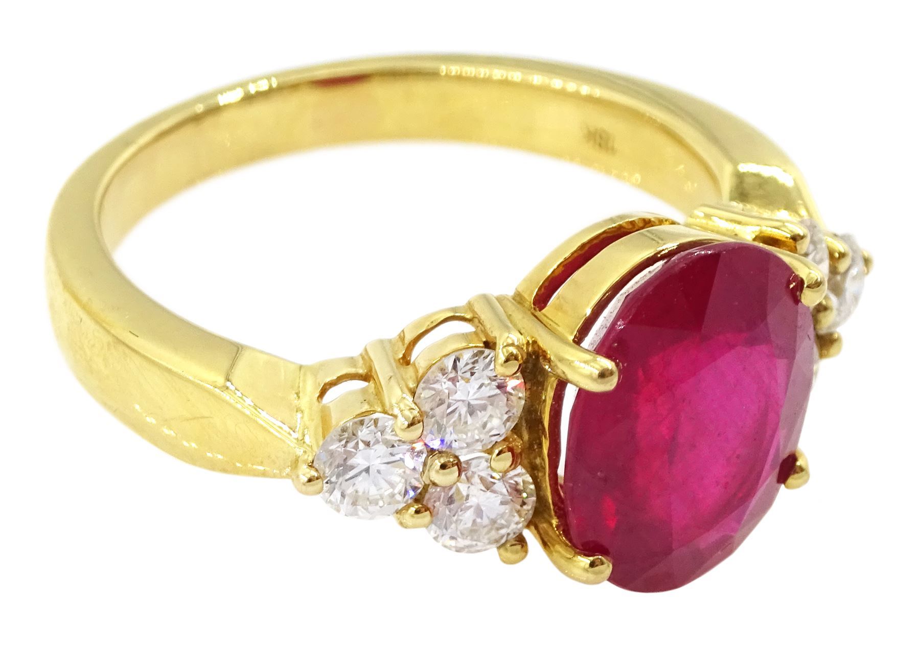 18ct gold ruby and diamond ring, single oval cut ruby of approx 5.35 carat, with three round brilliant cut diamonds set either side, stamped, total diamond weight approx 1.00 carat