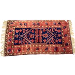 Persian red ground rug, central blue geometric pattern