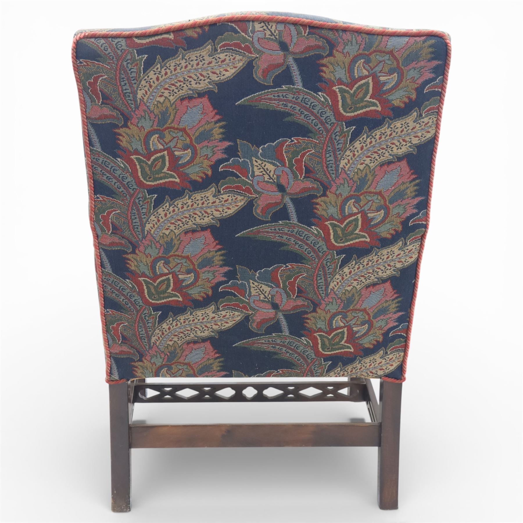 Early 20th century Chippendale revival Gainsborough elbow chair, rectangular upholstered back and seat covered in foliate patterned fabric, with open arms carved to the terminals and supports with pierced and geometric detail, raised on square section legs with blind fretwork panels