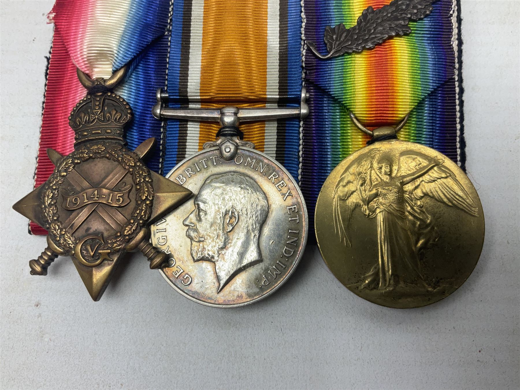 WW1 group of three medals comprising 1914-15 Star awarded to 1204 Pte. W.V. Furniss 20-London R. and British War Medal and Victory Medal with oak leaves awarded to Capt. W.V. Furniss; with ribbons; displayed on board for wearing; some biographical details