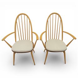 Ercol - elm dining chairs, set of six including two armchairs, arched spindle backs over shaped elm seats with upholstered pads, tapering beech legs joined by stretchers