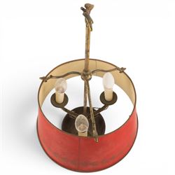 Bouillotte lamp, the adjustable red tole shade above three brass sconces upon a circular dished base, H54cm