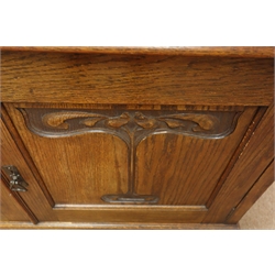  Arts & Crafts oak sideboard, projecting cornice, bevel edged mirrors, turned side supports, above two ogee front drawers, two panelled cupboard doors with foliate carvings on base plinth, W122cm, H180cm, D55cm  