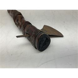 Tribal Art - an African axe, possibly Yoruba, the bone shaft carved as two cord bound stylised figures with iron fan-shaped blade, L35cm overall; and 19th century harpoon or spear head of square section with two long fixing arms on cut-down ash shaft L57cm (2)