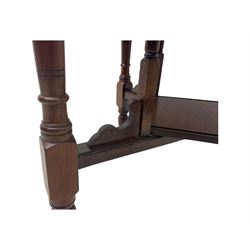 Victorian oak occasional table, octagonal top with bevelled edges, lower section fitted with a square undertier united by decorative shaped stretchers, on turned supports with castors