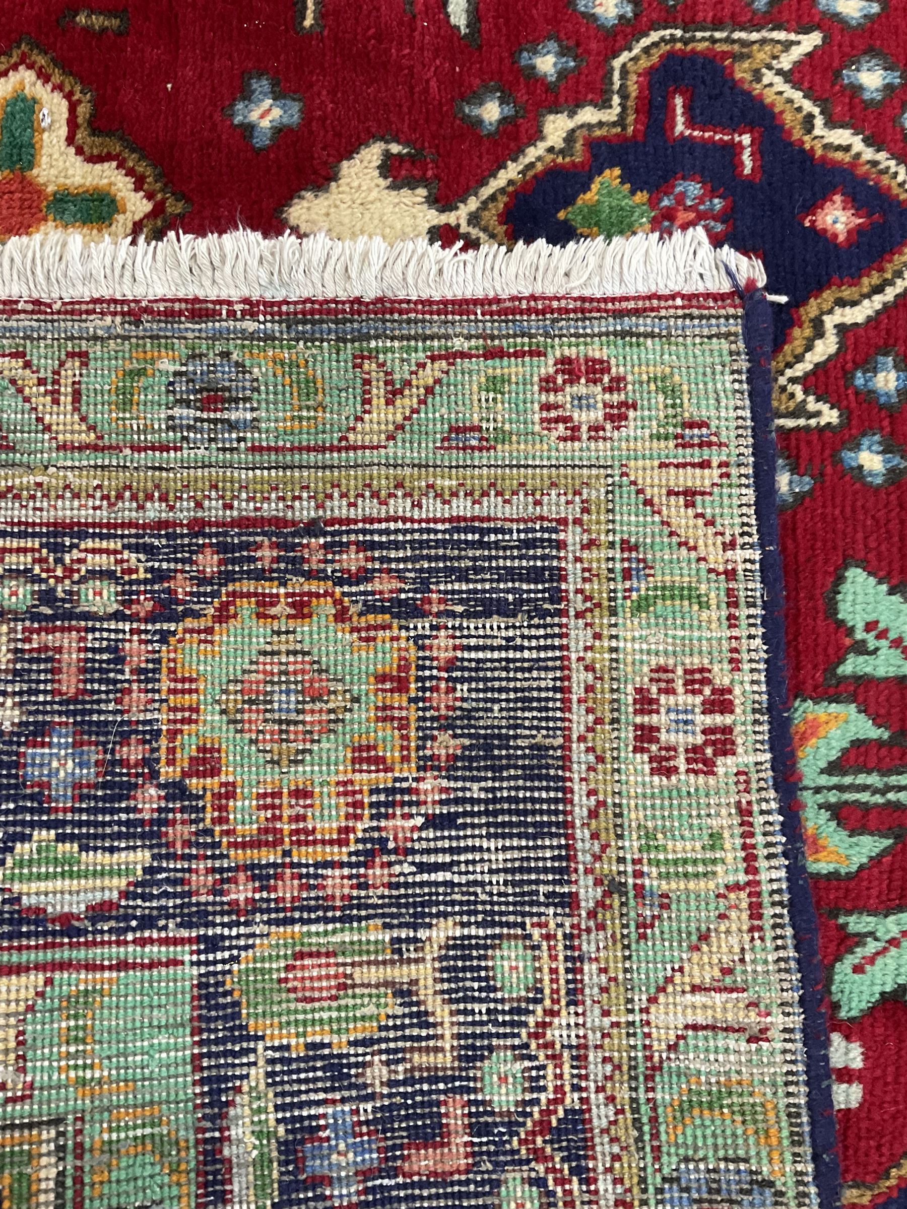 Qashqai red and blue ground rug, with central medallion, green repeating border with geometric motifs 