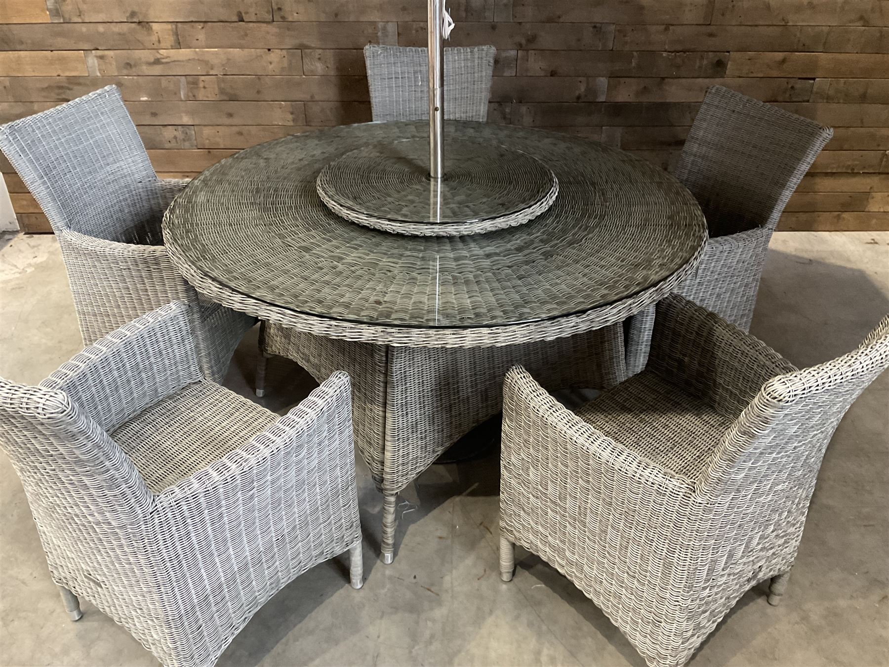 LeisureGrow circular rattan garden table, with lazy Susan, five armchairs with cushions, parasol and weighted base, with glass tops