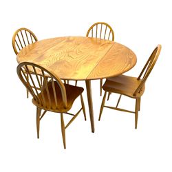 ercol elm and beech dining table, oval drop leaf top, and set four hoop and stick back dining chairs