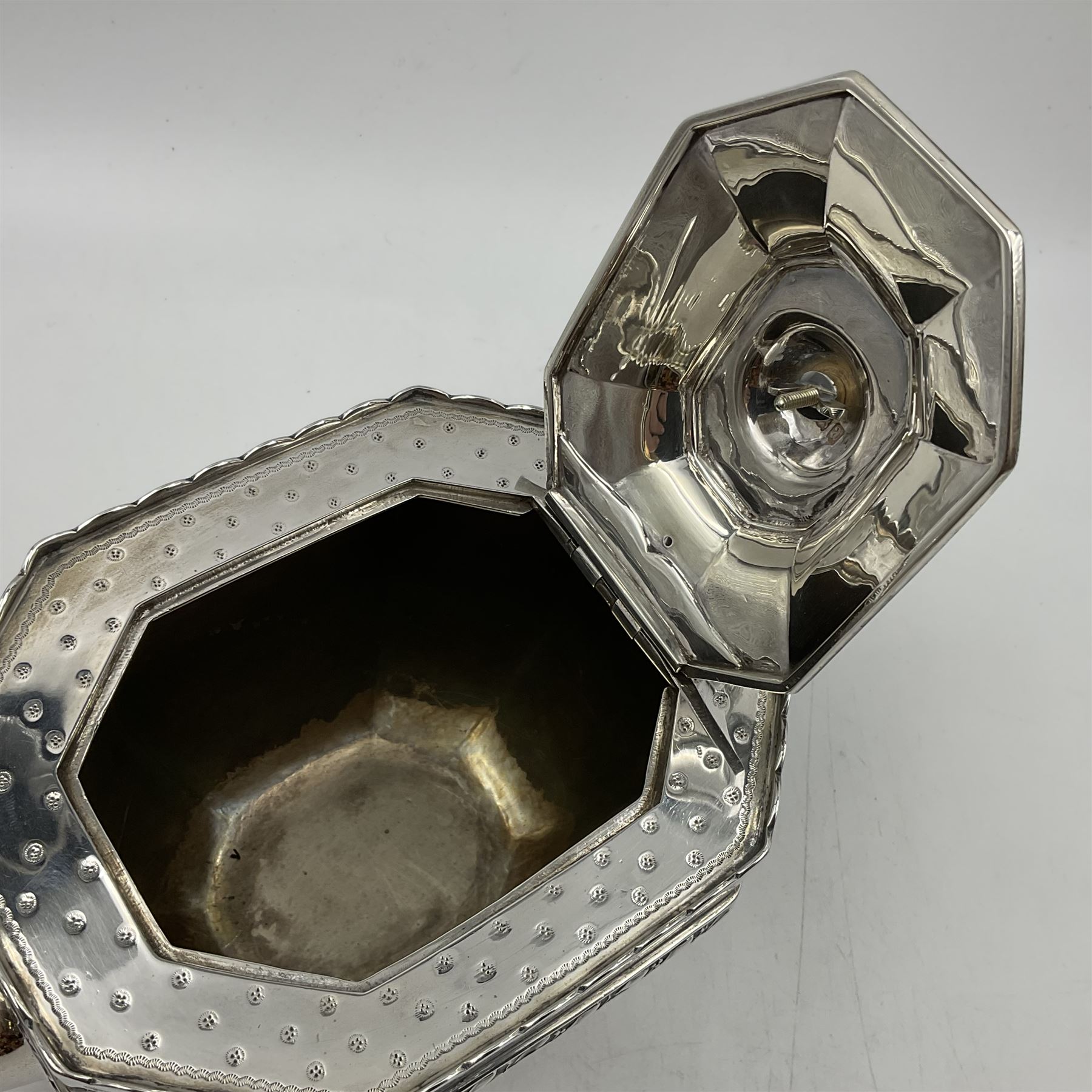 Victorian silver four piece tea service, comprising teapot, teapot stand, twin handled open sucrier and milk jug, each of octagonal form with foliate bud border and engraved decoration including crest to canted panels, and vacant panels, the teapot with ivory finial to the hinged cover and later wooden handle, hallmarked Edward Barnard & Sons Ltd, London1896, teapot including finial H15cm, milk jug including handle H16cm, teapot stand W11.5cm

This item has been registered for sale under Section 10 of the APHA Ivory Act