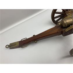Large model brass cannon, upon wooden base, together with two similar smaller cannons, largest L48cm