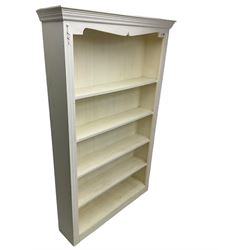 White painted open bookcase, projecting moulded cornice over four shelves, fluted uprights, on plinth base
