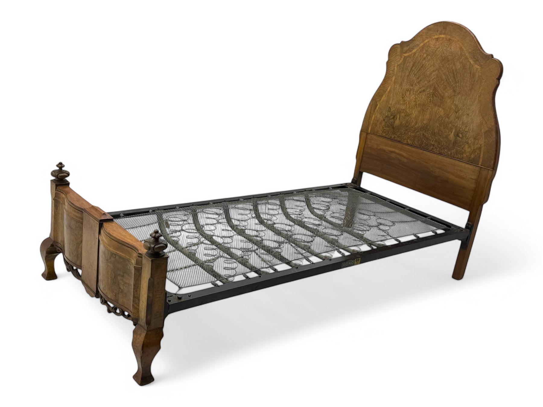 Mid-20th century walnut single bedstead, high shaped headboard, footboard with turned finials and scrollwork carvings, complete with 'Vono' iron frame, raised on cabriole supports