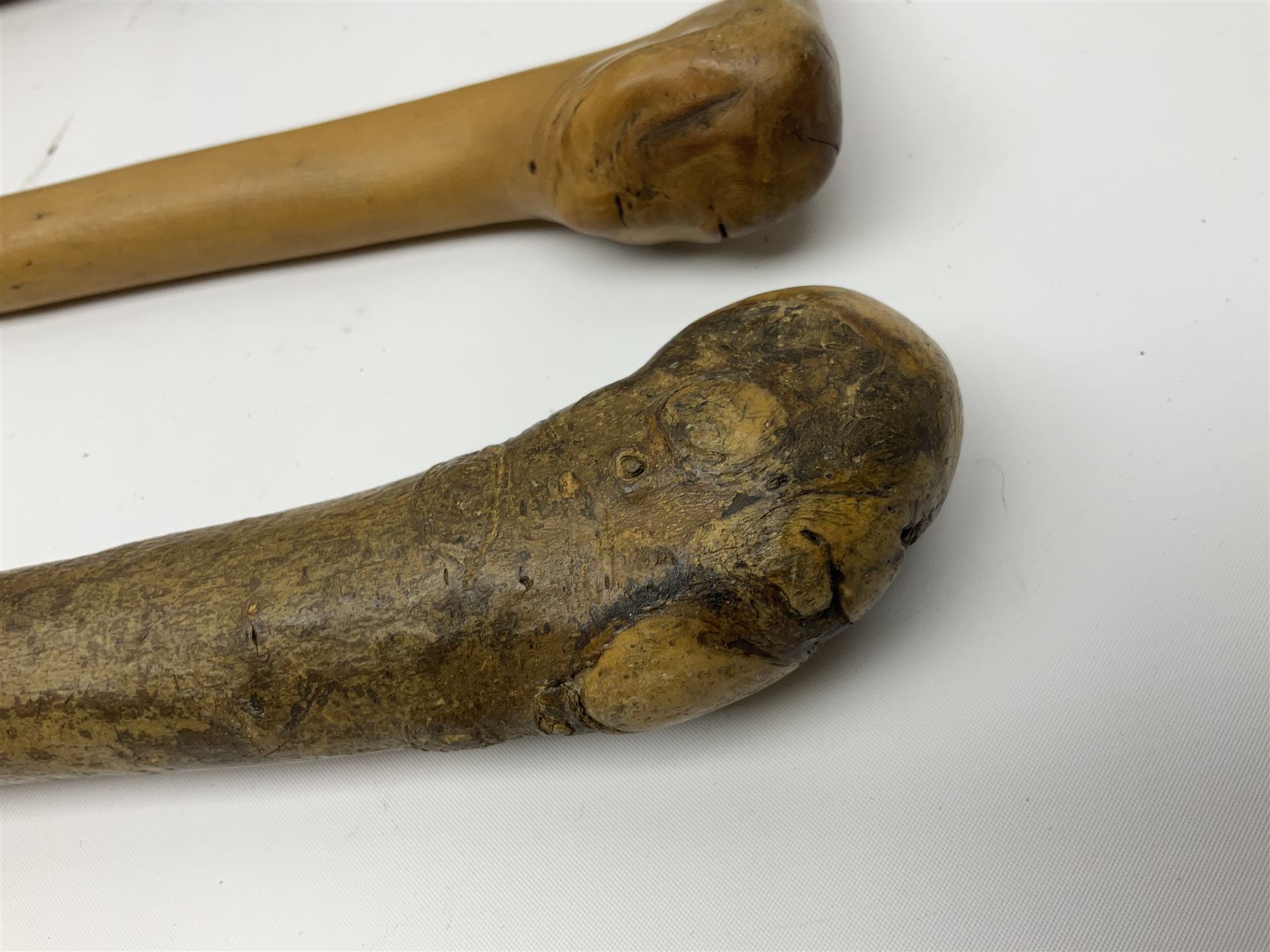 Four wooden walking canes, including a carved mahogany snooker cue example, tallest H86cm