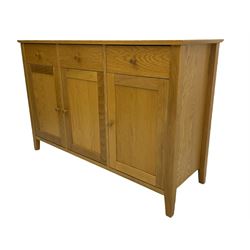 Light oak finish sideboard, fitted with three drawers and cupboards