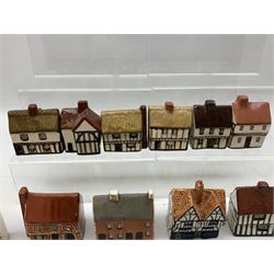 Twenty studio pottery figures of houses and cottages, comprising seventeen Mudlen End Studio Felsham Suffolk examples and two John Putman's Heritage Houses examples