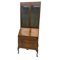 Early 20th century walnut bureau bookcase, two glazed doors over fall front, fitted with three drawers, on shell carved cabriole feet