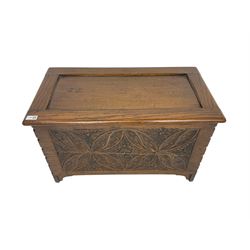 Small 20th century oak coffer, panelled hinged lid over carved front, decorated with floral lozenge motifs, on bracket feet
