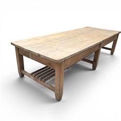 Large early/mid-20th century pine table or work bench, rectangular six plank top on eight tapering supports joined by slatted undertier
