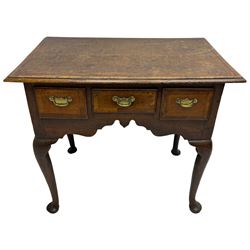 George III oak lowboy, rectangular top with walnut banding and moulded edge, fitted with three drawers with pressed brass handle plates and pulls, the shaped apron over cabriole supports with pad feet