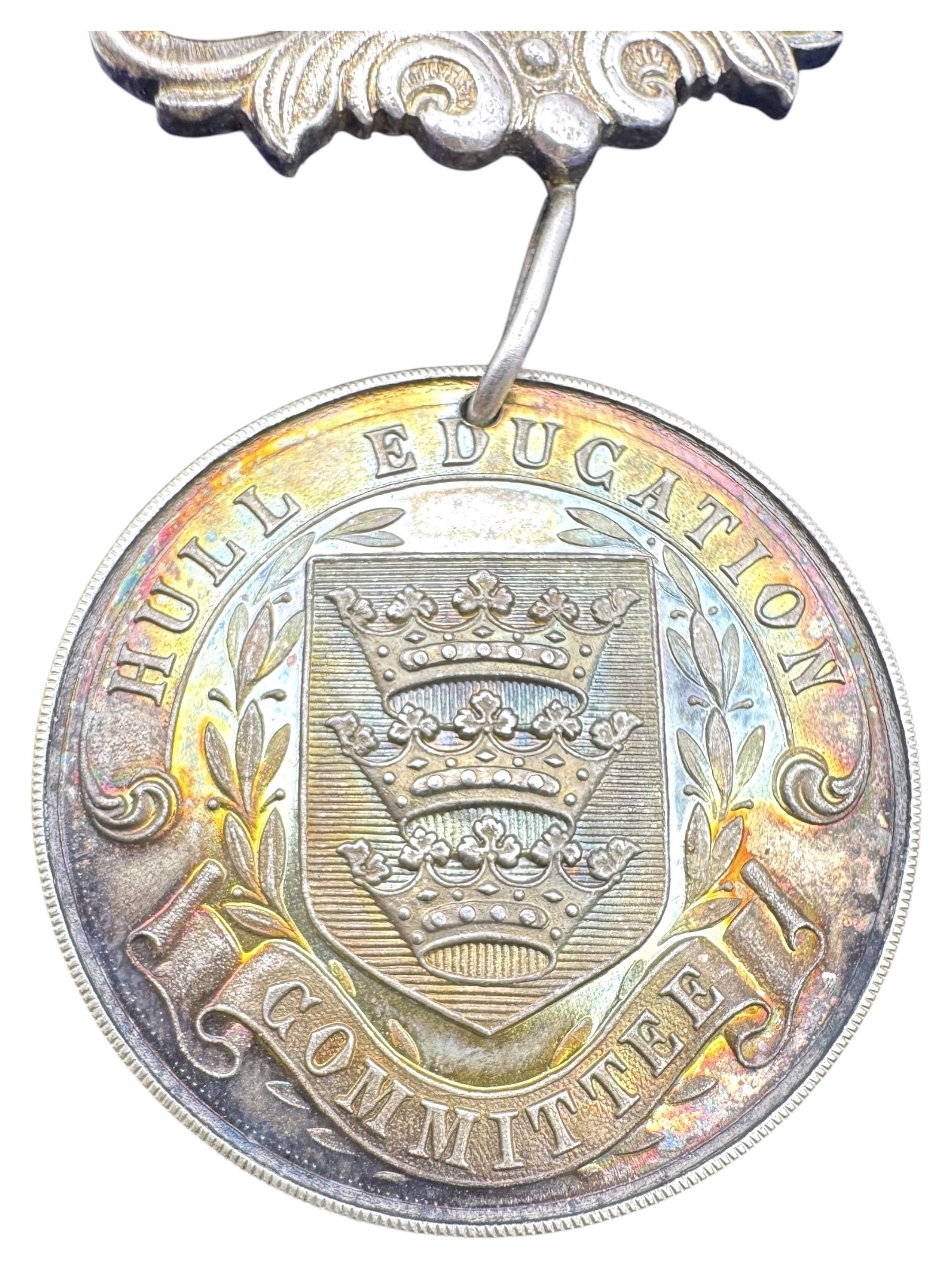 Silver perfect attendance medal for Hull Education Committee, bronze medallion for Hull Young Peoples Christian and Literary Institute and a guild of building medallion, all cased