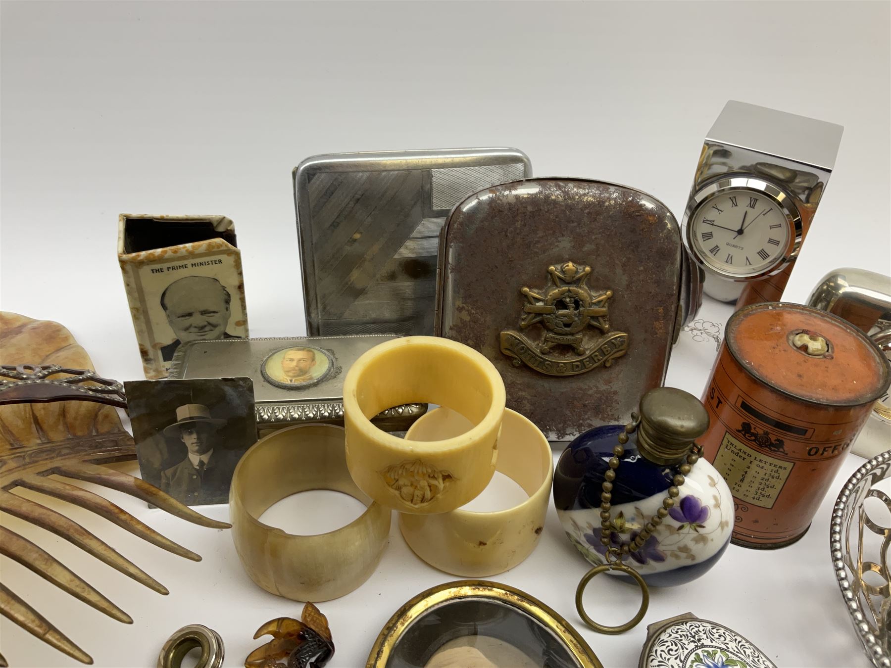 A group of assorted collectables, to include small oval purple guilloche enamel frame, WWII matchbox holder depicting Winston Churchill, Halcyon Days enamel box, Ronson table lighter, ebonised glove stretchers, ivory napkin ring, mother of pearl handled button hook, engine turned cigarette case, etc. 