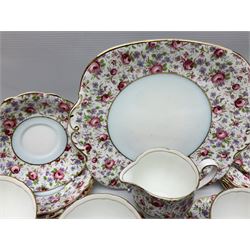 Windsor tea service for six decorated with blooming pink roses and purple flowers amongst foliage