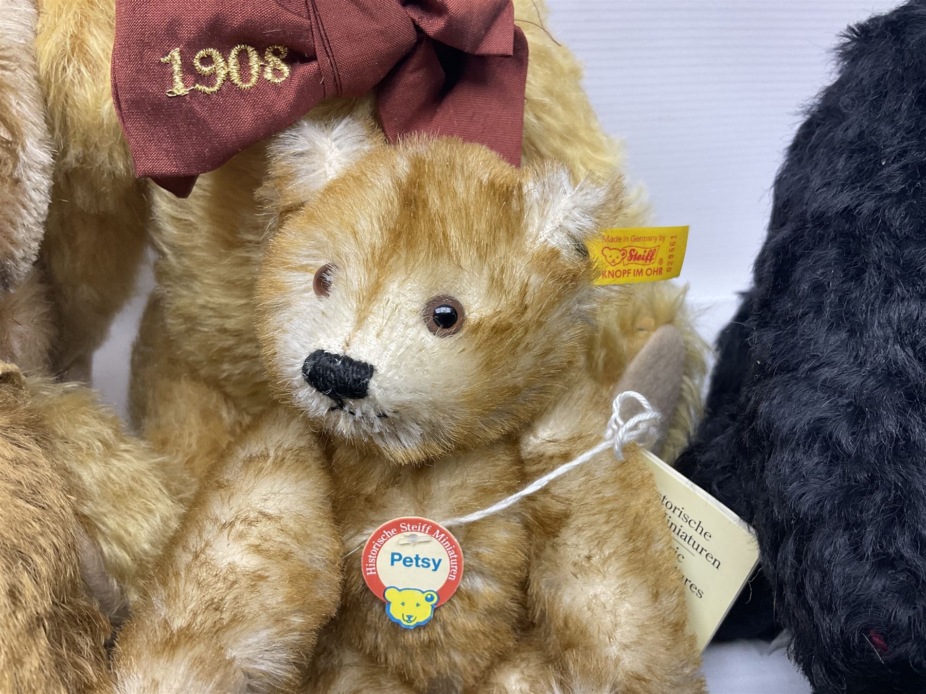 Seven modern Steiff teddy bears comprising two limited edition '1908 Paul the Growler' bears Nos.1124/3000 and 1310/3000; 028649 Classic Teddybear 23; 005992 Classic Teddybear 28 (black); 071249 Mungo Meerkat 30; 079139 Reclining dog for American Kennel Club; and 029561 Petsy gespitzt (1928) 16cm; together with a Mrs. McCatty's limited edition 2156 Sophie bear No.1557/1750; all unboxed but most with labels (8)
