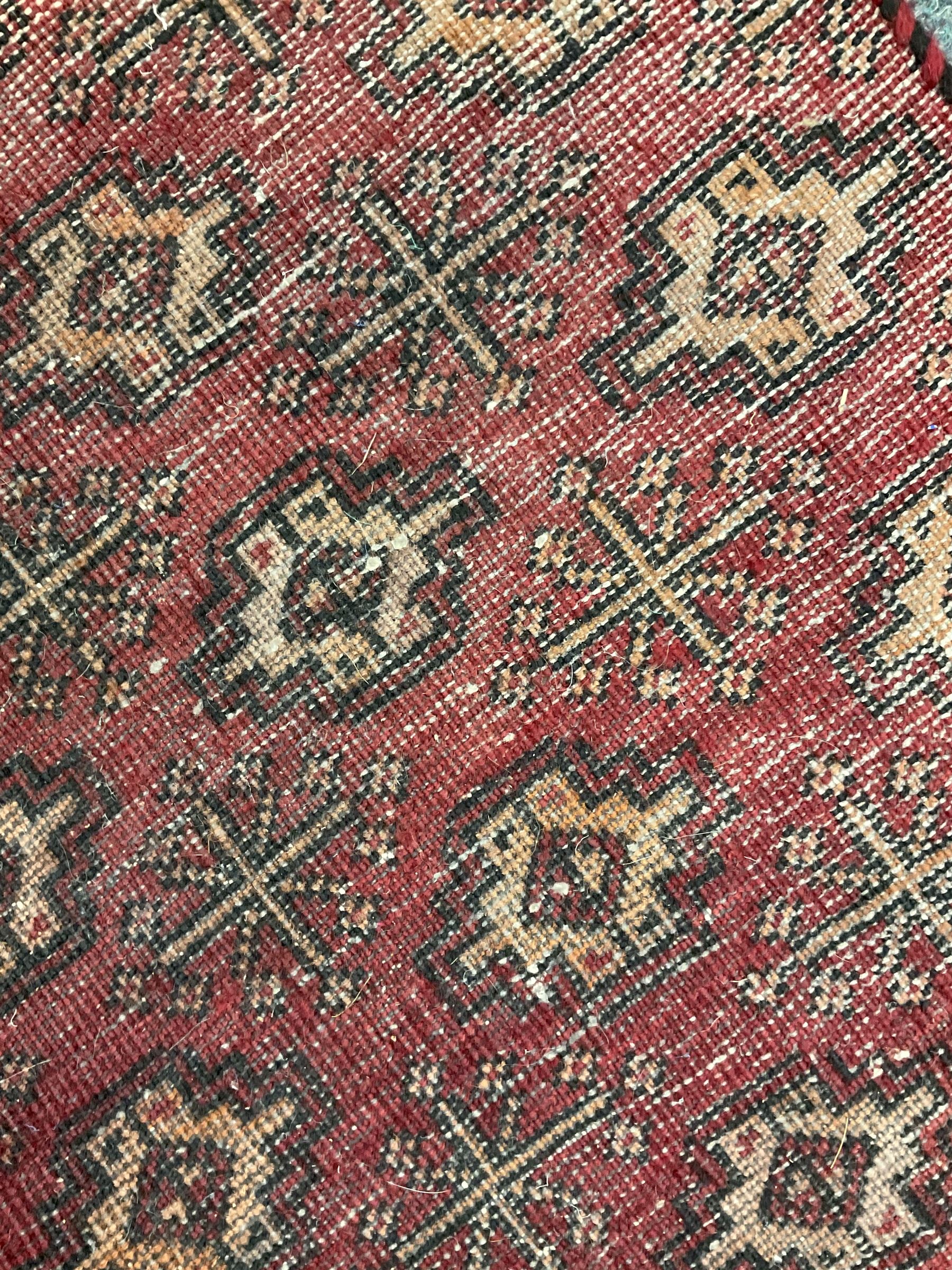 Persian red ground runner, decorated all over with geometric and star