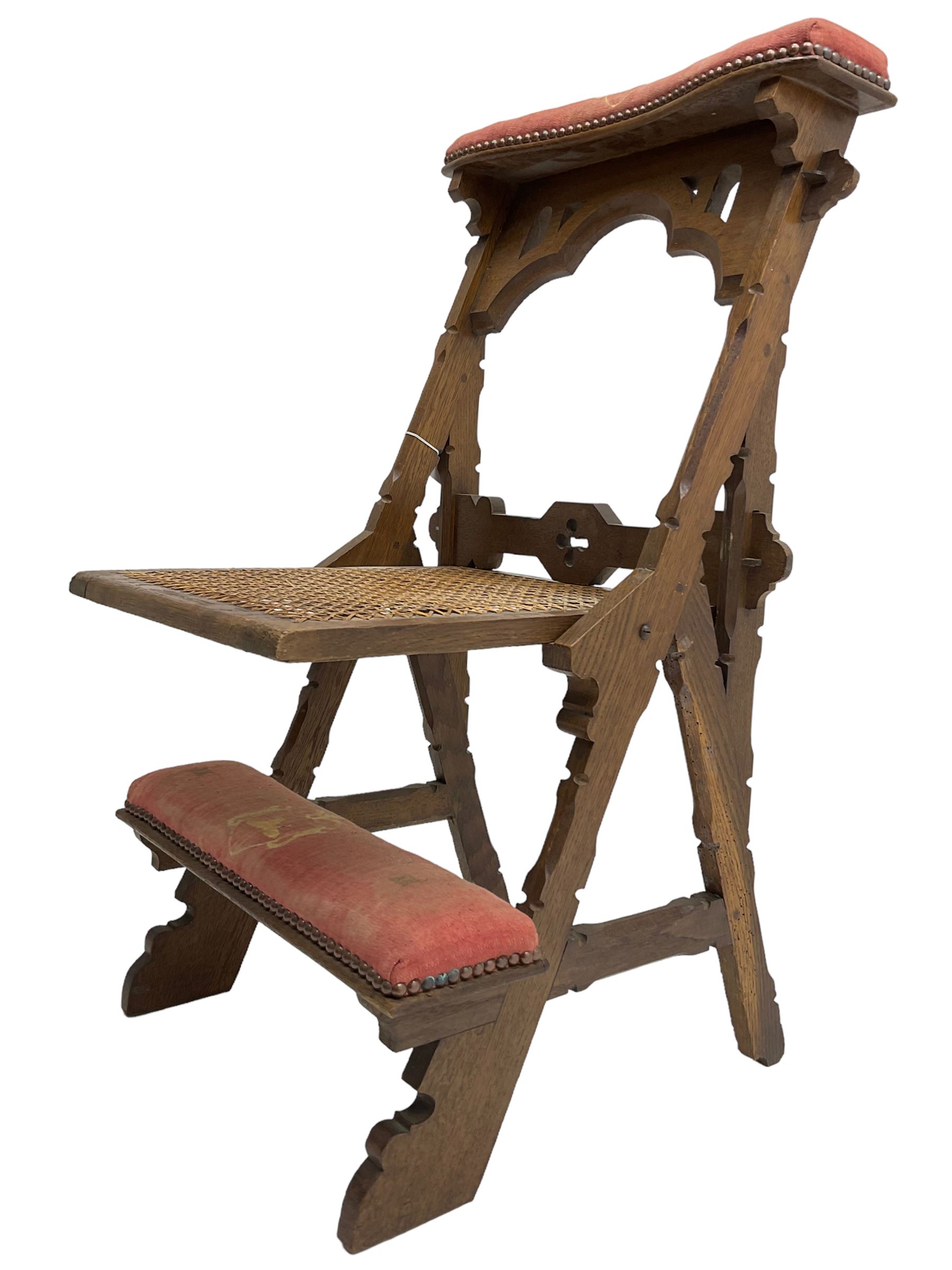 Late Victorian oak metamorphic prie-dieu chair, ecclesiastical design with pegged construction, upholstered kneel rest and top rest, hinged cane work seat