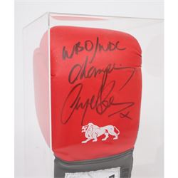 Lonsdale boxing glove, signed by Nigel Benn in black marker pen, in acrylic display box