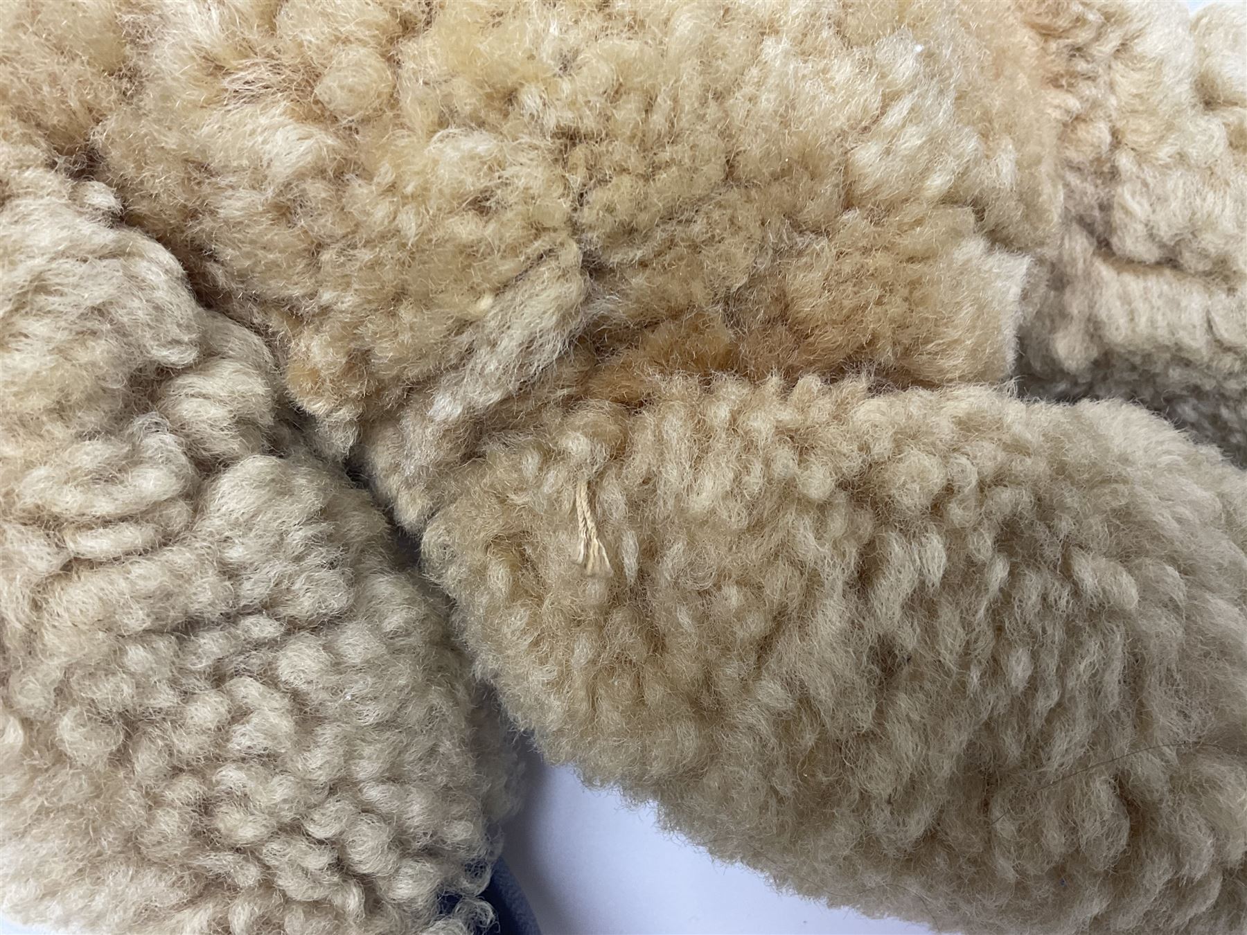 1950s sheepskin plush covered teddy bear with musical movement, the revolving head with applied eyes, leather nose and stitched mouth, jointed limbs with leather pads H50cm