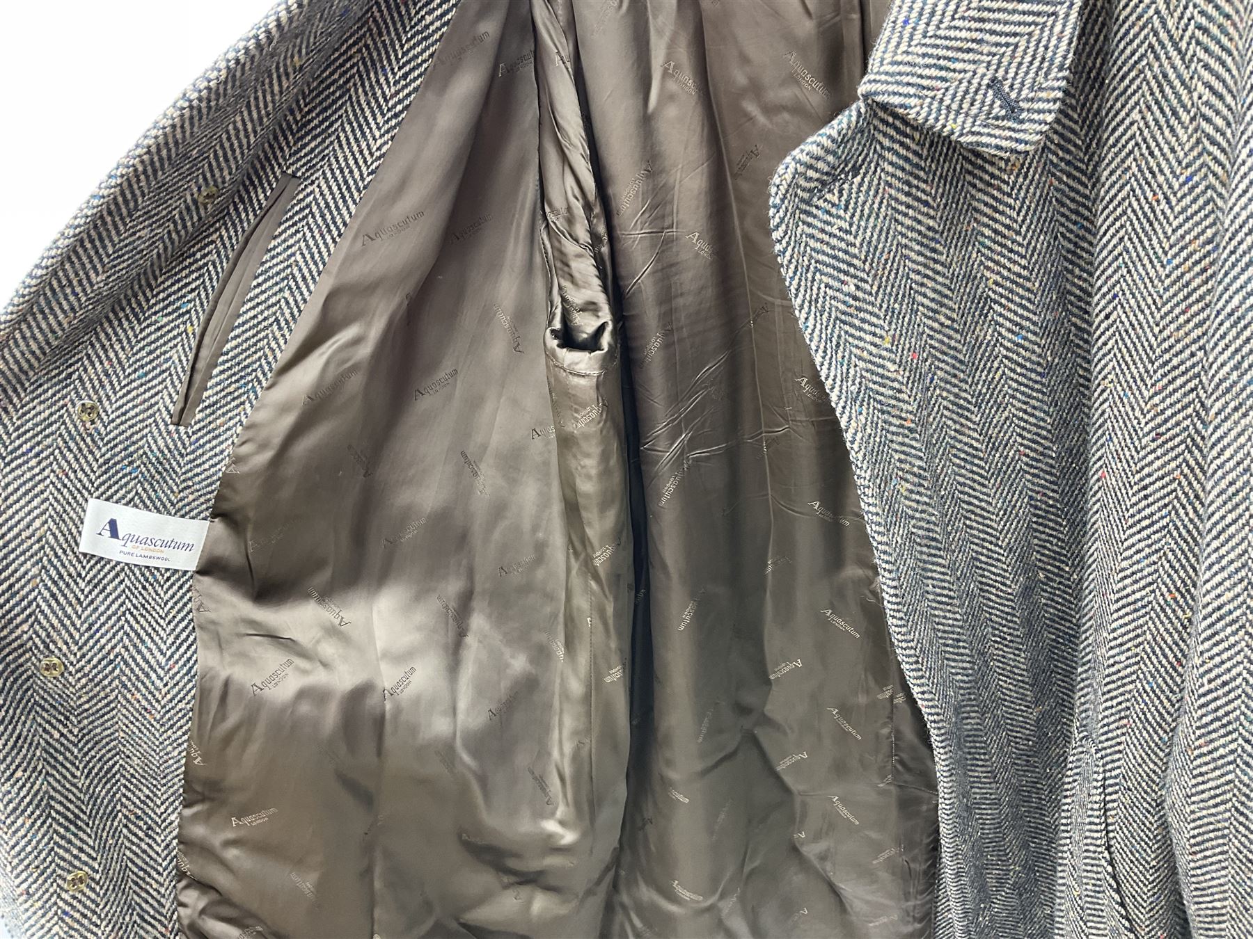 Men's Aquascutum lambs wool herringbone tweed coat with silk lining, 46 Reg, together with a further Men's Aquascutum grey wool duffle coat, with cheque lining and horn buttons, 46