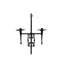 Ironwork candle holder stand, with stamped decoration, adjustable two branch sconces with scrolled iron work, twist stem with arched supports with scrolled terminals