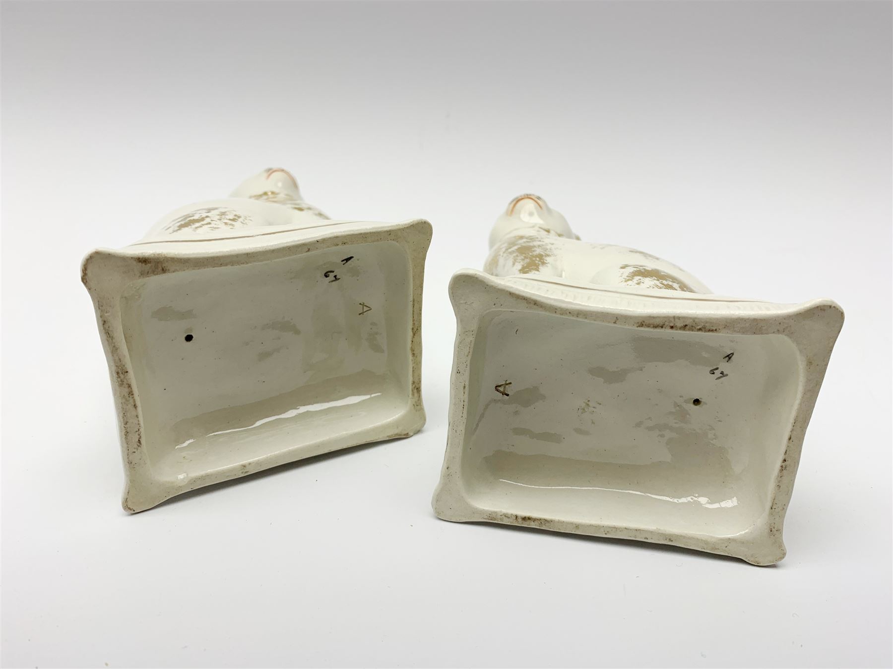 Pair of Victorian Staffordshire cats, modelled seated upon cushions, with gilt detail throughout, H18cm