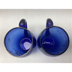 Pair of Victorian cobalt blue glass cups with gilt and painted decoration, entitled Hope's the Balm of Life and Love me as I Love Thee, H8.5cm