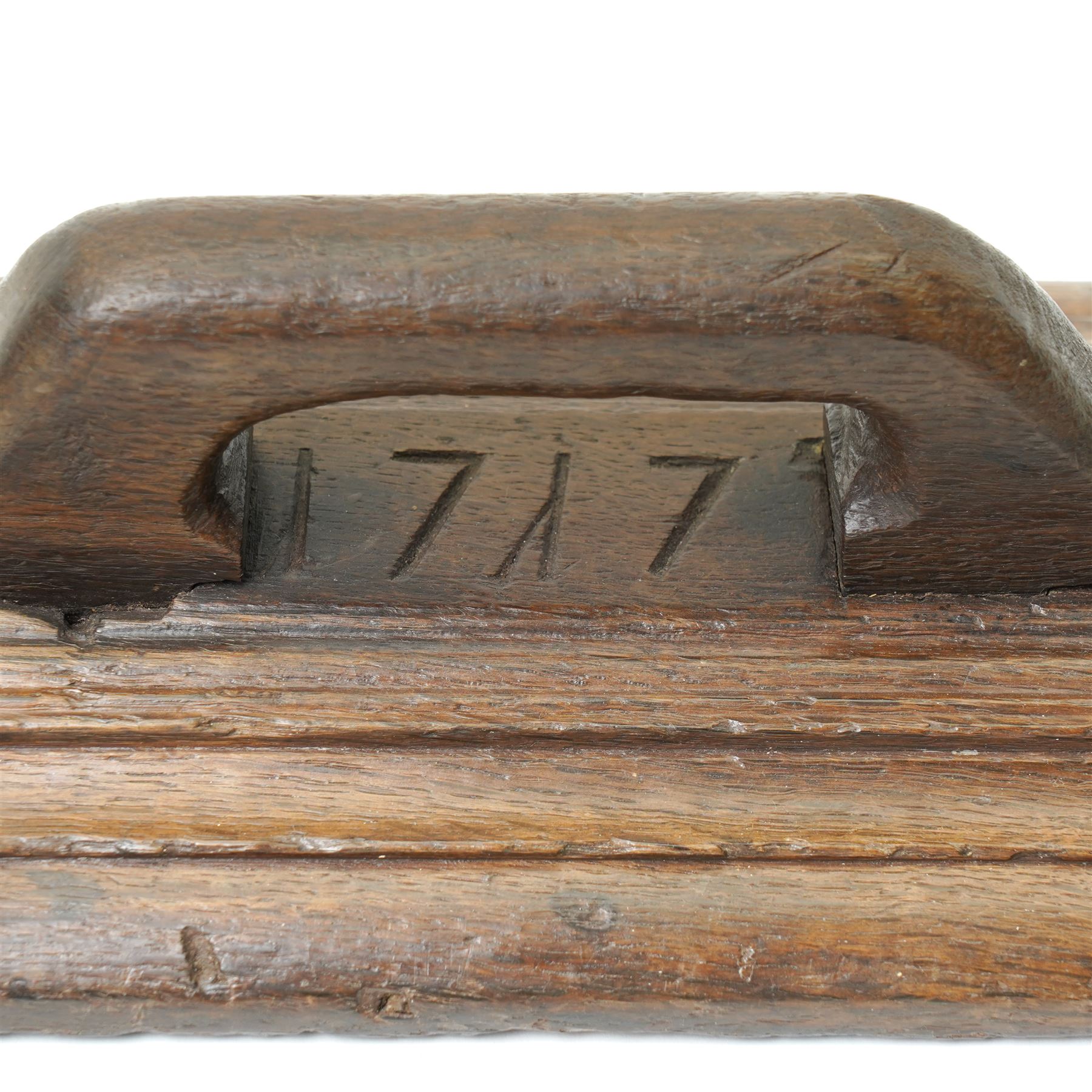 18th century oak mangle board, carved with scrolled motifs, incised 'ANNO 1717', W57cm 