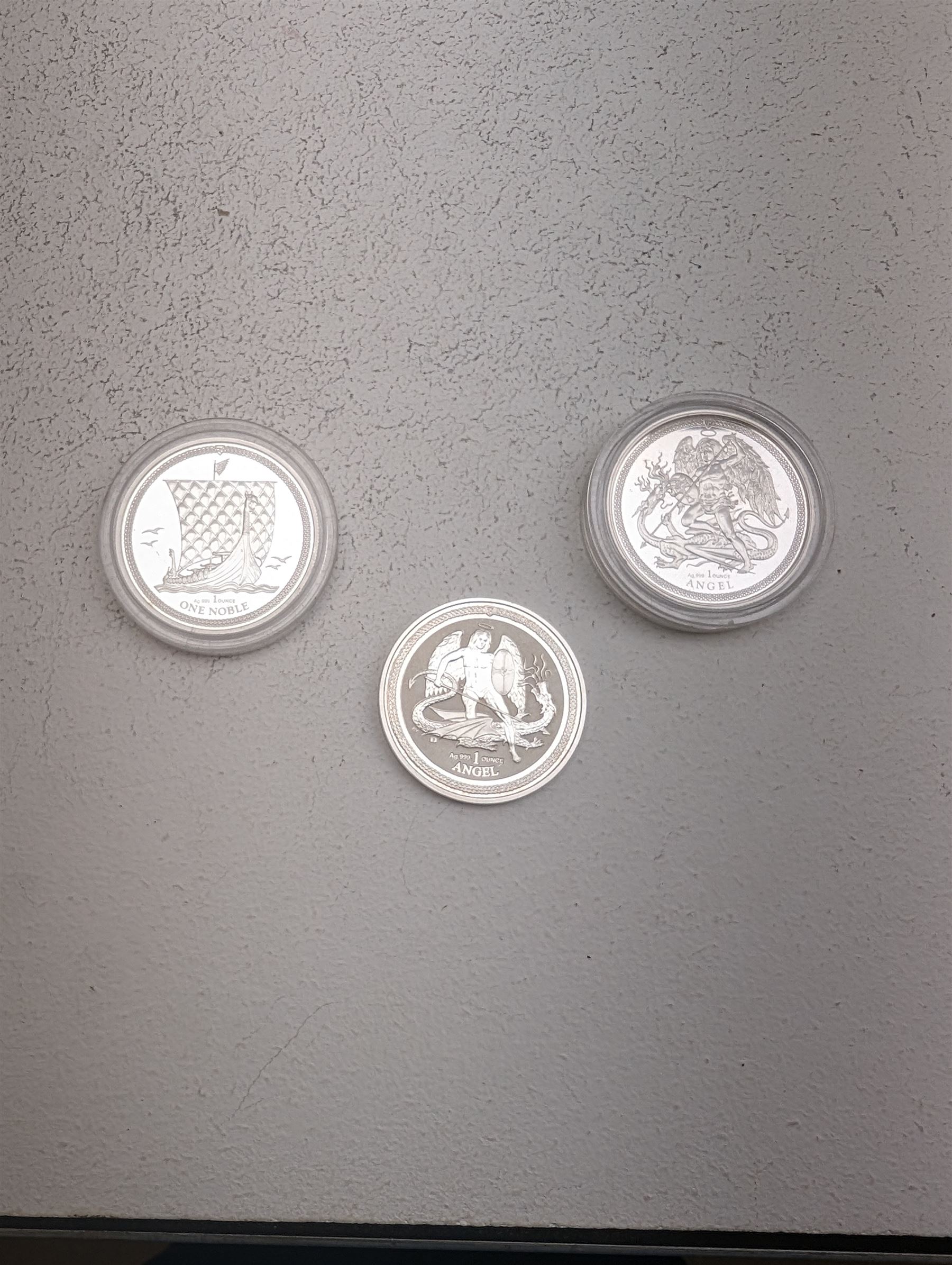 Three Queen Elizabeth II Isle of Man one ounce fine silver coins, comprising 2016, 2018 one angels and 2018 one noble 