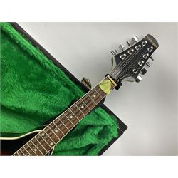 Stagg eight-string mandolin, model M20, the black lacquered body with simulated ivory trim, bears label numbered 070465 L70cm; in green painted scratch-built wooden case