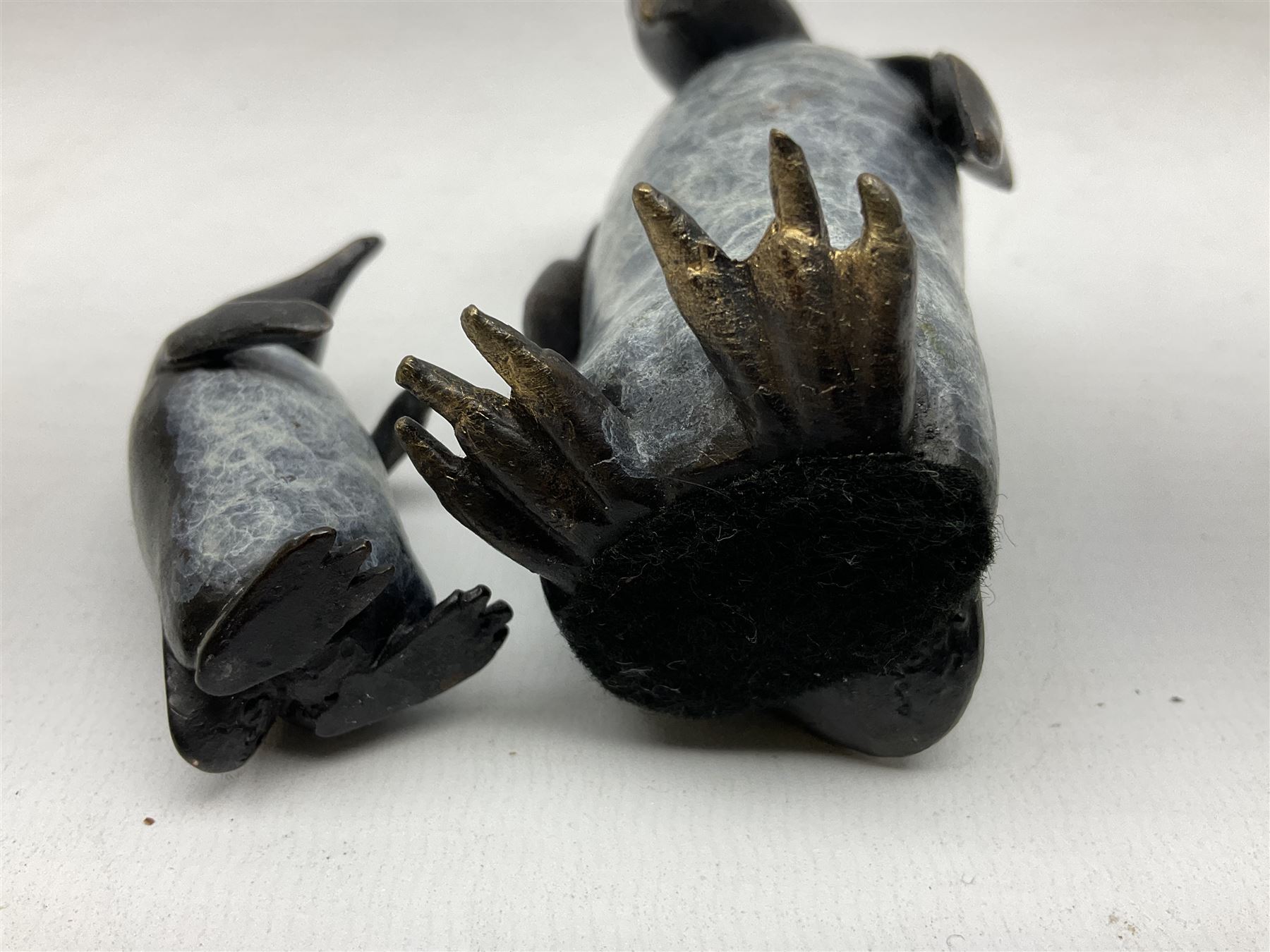 Steve Boss (British 1970-); Bronze figure group of a family of Emperor penguins, entitled Waddle, all with artists monogram beneath, tallest H12cm