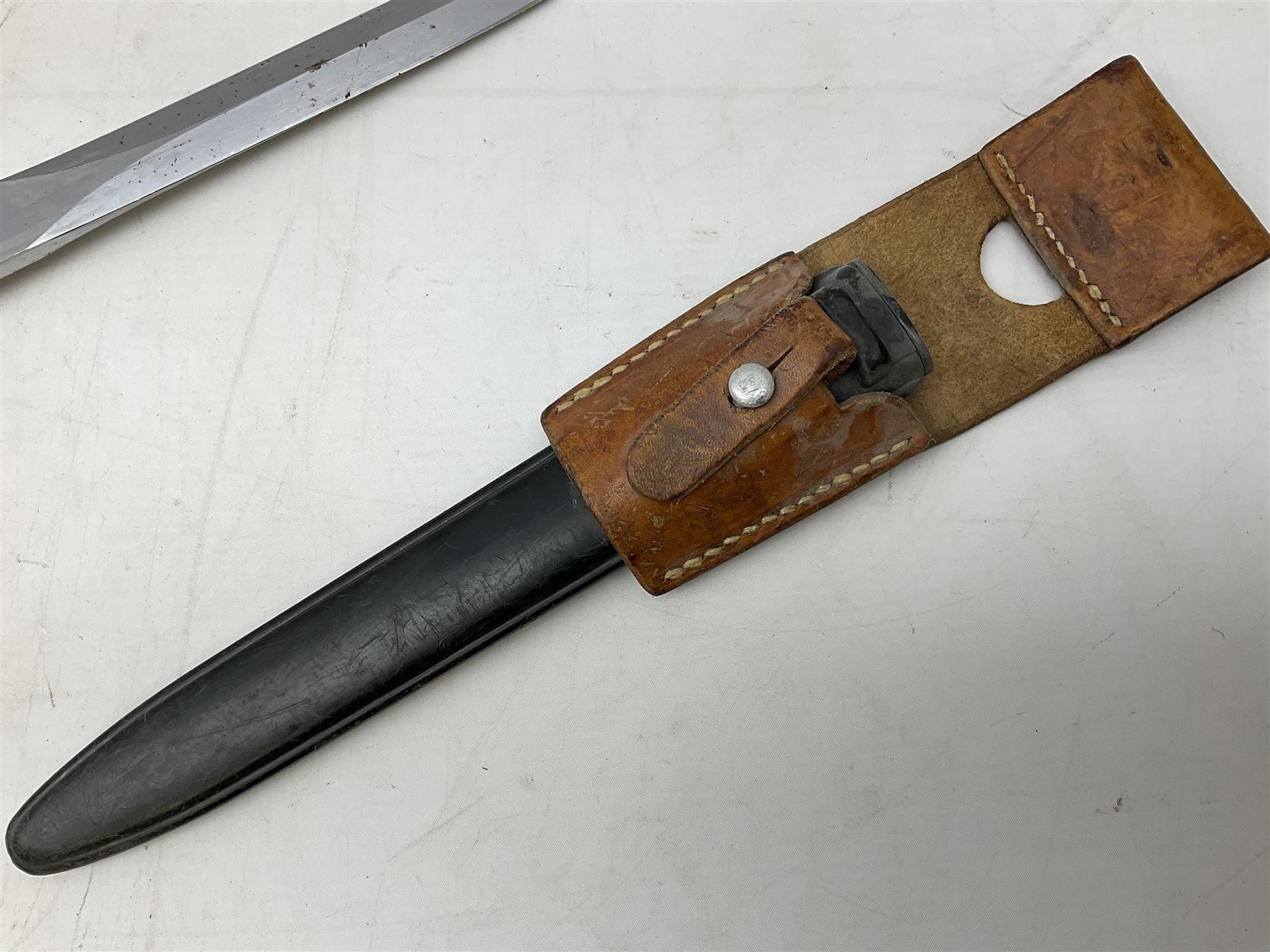 Swiss Model 1957 SIG rifle bayonet by Wenger with 23.5cm steel blade numbered 350857; in plastic scabbard with leather frog stamped GSCH 85 L38cm overall; and Egyptian Hakim rifle bayonet with the same script number to the grip and steel scabbard (2)