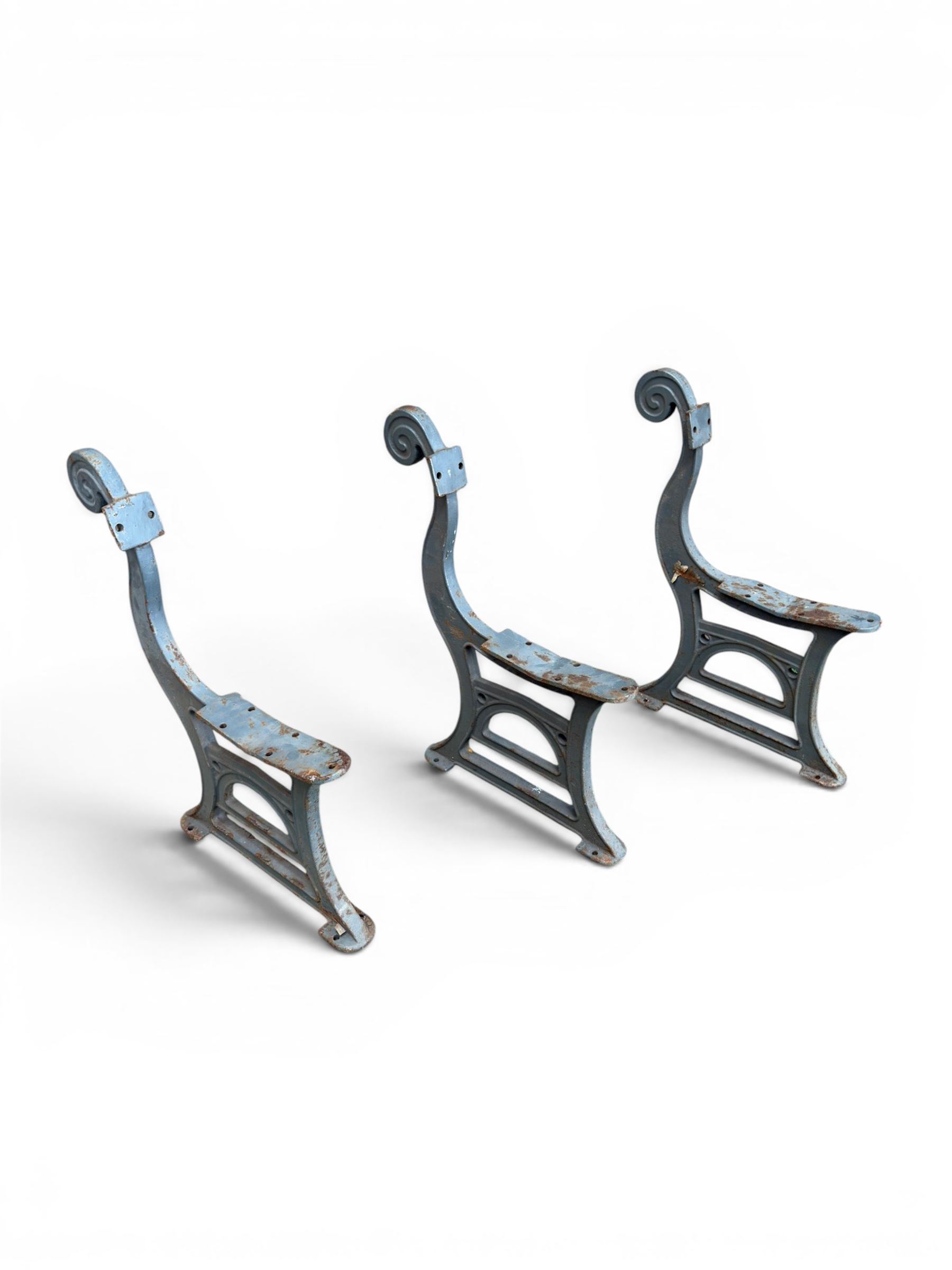 Set of three mid-20th century cast iron towns and park bench ends, scrolling pediment over arched stretchers, length to be altered as desired
