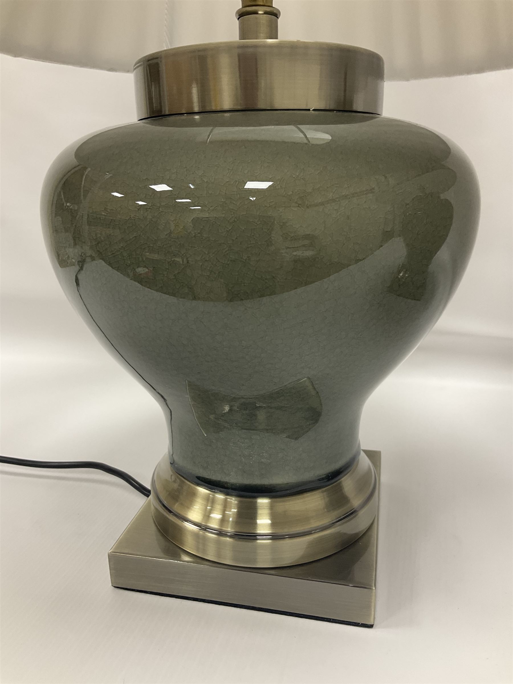 Pair of table lamps of squat baluster form, with a crackle glaze to a dark grey ground, upon a square base, including shade H57cm