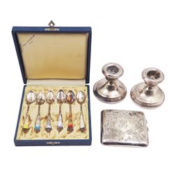 Group of silver, comprising set of six Norwegian enamel coffee spoons, in fitted case, cigarette case, with engraved initials and C scroll decoration and a pair of silver mounted dwarf candlesticks, all stamped or hallmarked 