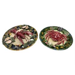Two 20th Century Portuguese Palissy style Majolica wall plates, one depicting a crab, the other a lobster each to the centre modelled in relief surrounded by encrustations and shells, both with impress marks beneath, D32cm