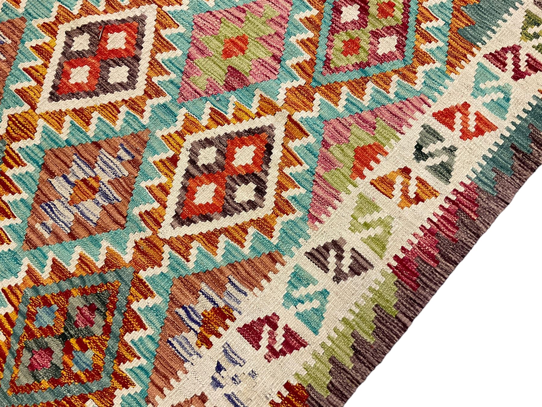 Anatolian Turkish Kilim multi-colour rug, decorated with all over lozenges in contrasting colours with ivory outline, the multi-band ivory border with repeating geometric shapes and small lozenges or diamonds
